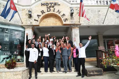 a group of people standing in front of a building at Hotel Los Jardines in Santiago de los Caballeros