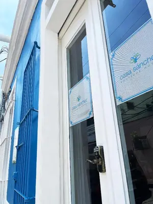 a door of a building with signs on it at Hotel Boutique Casa Sánchez in Santo Domingo