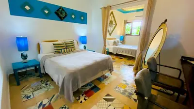 a bedroom with a bed and a mirror at Hotel Boutique Casa Sánchez in Santo Domingo