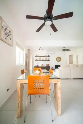 a dining room with a table and a ceiling fan at Villa Pauline in Bayahibe