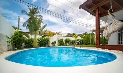 a swimming pool in the backyard of a house at Villa Pauline in Bayahibe