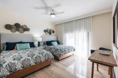 a bedroom with two beds and a window at 3BR apartment with balcony in Portillo - Terrenas in Abra Grande