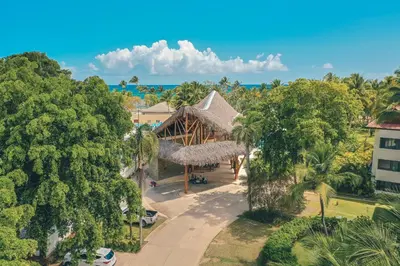 an aerial view of a resort with trees and the ocean at 3BR apartment with balcony in Portillo - Terrenas in Abra Grande