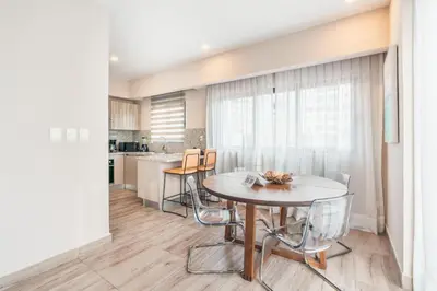 a kitchen and dining room with a table and chairs at Fully Serviced Apartment at Regatta Living II - 302 in Santo Domingo