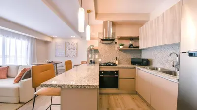 a kitchen and living room with a counter top at Fully Serviced Apartment at Regatta Living II - 304 in Santo Domingo