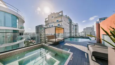 a balcony with a swimming pool on top of a building at Fully Serviced Apartment at Regatta Living II - 905 in Santo Domingo