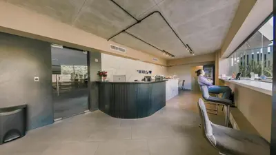 a bar in the middle of a room with chairs at Fully Serviced Apartment at Regatta Living II - 905 in Santo Domingo