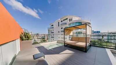 an apartment balcony with a view of a building at Fully Serviced Apartment at Regatta Living II - 907 in Santo Domingo