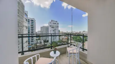 a balcony with chairs and a view of the city at Fully Serviced Apartment at Regatta Living II - 907 in Santo Domingo