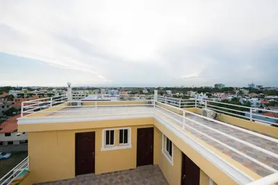 a balcony with a view of the city at Tropical Island Aparthotel - Santo Domingo EsteRD in Santo Domingo