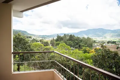 a balcony with a view of the mountains at Hotel Altocerro in Constanza