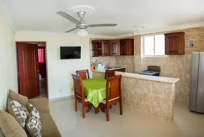 a kitchen with a table and chairs in a room at 1-Bedroom Apartment Retreat in Santo Domingo Este in La Viva
