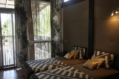 a bedroom with two beds and a large window at Chaykovski Boutique H in Las Terrenas