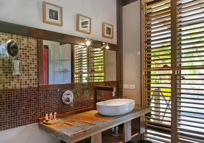 a bathroom with a sink and a mirror at Chaykovski Boutique H in Las Terrenas
