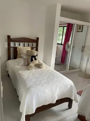 a teddy bear sitting on a bed in a bedroom at Great location, right downtown Puerto plata . in San Felipe de Puerto Plata