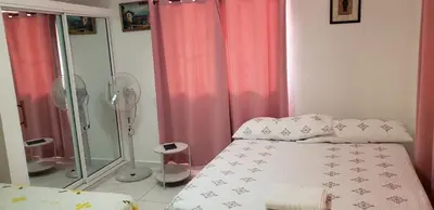 a bedroom with a bed and a glass shower at Great location, right downtown Puerto plata . in San Felipe de Puerto Plata
