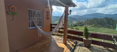 a hammock on a balcony of a house with a view at Chulavista Constanza casa campito in Arroyo Frío