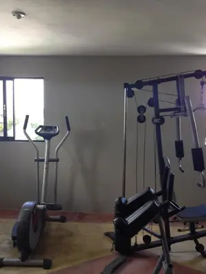 a gym with two exercise bikes in a room at Hotel Renacer in Santo Domingo
