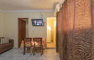 a living room with a table and chairs and a television at Double Room, Corales del SurOle Las Americas- Isabelita - Aeropuerto-Aeropuerto in La Viva