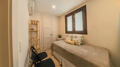 a small bedroom with a bed and a window at Special Price Deluxe 2BR at El Portillo in Las Terrenas