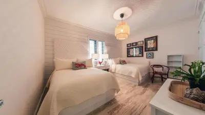 a bedroom with two beds and a table with a chair at Special Price Deluxe 2BR at El Portillo in Las Terrenas