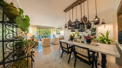 a dining room with a table and some plants at Special Price Deluxe 2BR at El Portillo in Las Terrenas
