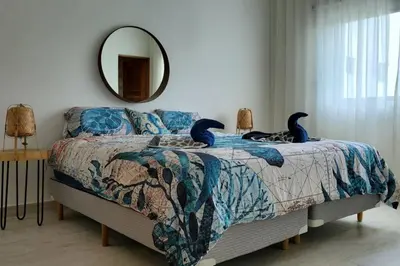 a bedroom with a bed with two birds on it at Samán Residences D3 in Las Terrenas