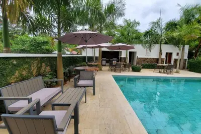 a pool with chairs and umbrellas next to a resort at Samán Residences D3 in Las Terrenas