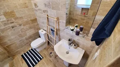 a bathroom with a sink and a toilet and a mirror at Samán Residences D3 in Las Terrenas