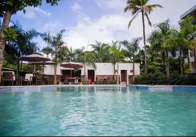 a large swimming pool with chairs and umbrellas at Samán Residences D3 in Las Terrenas