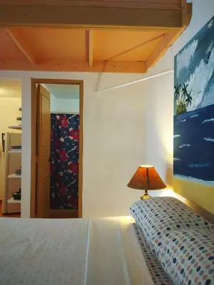 a bedroom with a bed with a lamp on it at Estudio Jardín Escondido in Las Galeras