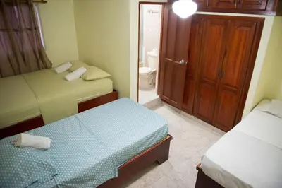 a small bedroom with two beds and a bathroom at 2 Bedroom 2 Bathroom Apartment- Corales del Sur Ole Las Americas- Isabelita in La Viva