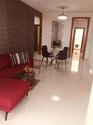 a living room with a red couch and a table at Verdana SFM A2 in San Francisco de Macorís