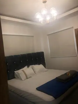 a bed with a black padded headboard in a room at Verdana SFM A2 in San Francisco de Macorís