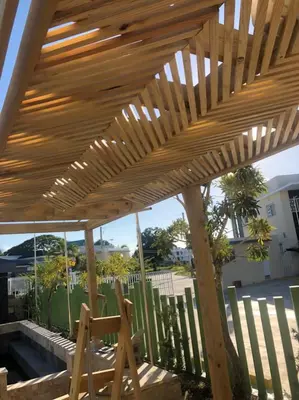 a wooden pergola with a bench under it at Verdana SFM A2 in San Francisco de Macorís