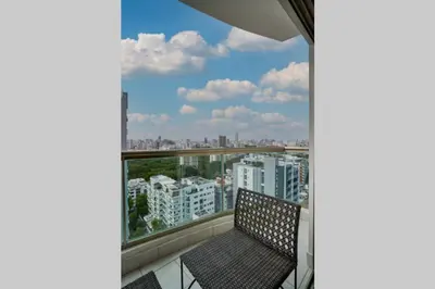 a balcony with two chairs and a view of the city at Escape Apartments, Balcony, Pool, Gym & Spa in La Julia in Santo Domingo