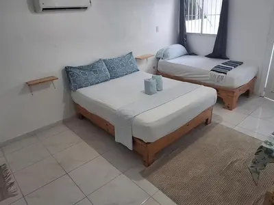 a bedroom with two beds in a room at Apartamento Los Blancos, a dos Minutos de los Patos Barahona in Enriquillo