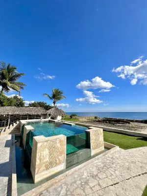 a swimming pool with a view of the ocean at Tritón Hotel Boutique & Restaurant in Guayacanes