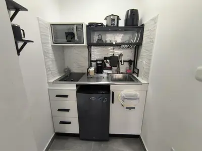 a small kitchen with a sink and a stove at La casita de Gazcue in Santo Domingo