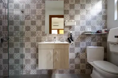 a bathroom with a toilet and a sink and a mirror at Escape Apartments, Balcony, Pool & Gym in La Julia in Santo Domingo