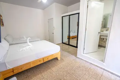 a bedroom with a bed and a large mirror at Room #24 at Waterfront Playa Alicia in Sosúa