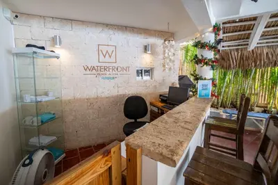 an office with a counter and a water room sign on the wall at Room #24 at Waterfront Playa Alicia in Sosúa