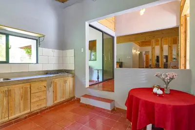 a kitchen with a table with a red table cloth on it at Casa Kafe in Cabrera