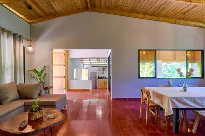 a living room with a table and a couch at Casa Kafe in Cabrera