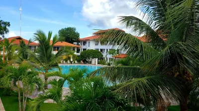 a view of a resort with a pool and palm trees at Residencial Paraiso Bayahibe in Bayahibe