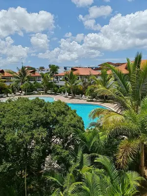 a view of a swimming pool with palm trees at Residencial Paraiso Bayahibe in Bayahibe