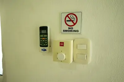 a no smoking sign and a no smoking sign on a wall at Bungalow #14 at Waterfront Playa Alicia in Sosúa