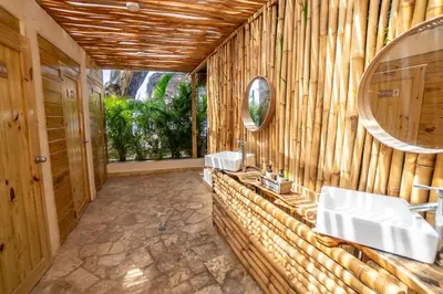 a bathroom with two sinks and a mirror at Bungalow #16 at Waterfront Playa Alicia in Sosúa