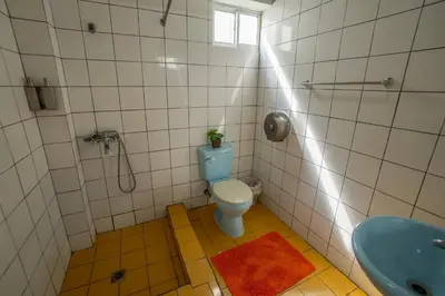 a bathroom with a toilet and a sink at Bungalow #17 at Waterfront Playa Alicia in Sosúa