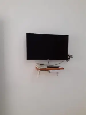 a flat screen tv on a white wall at Apartment #21 at Waterfront Playa Alicia in Sosúa